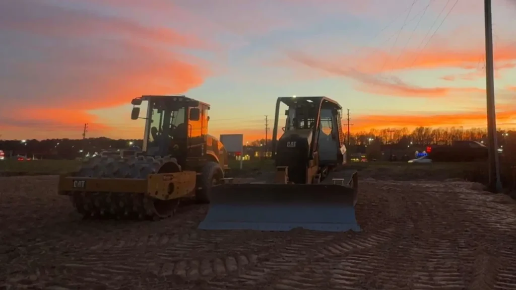 Heavy equipment performing commercial site preparation for a new construction and development project.
